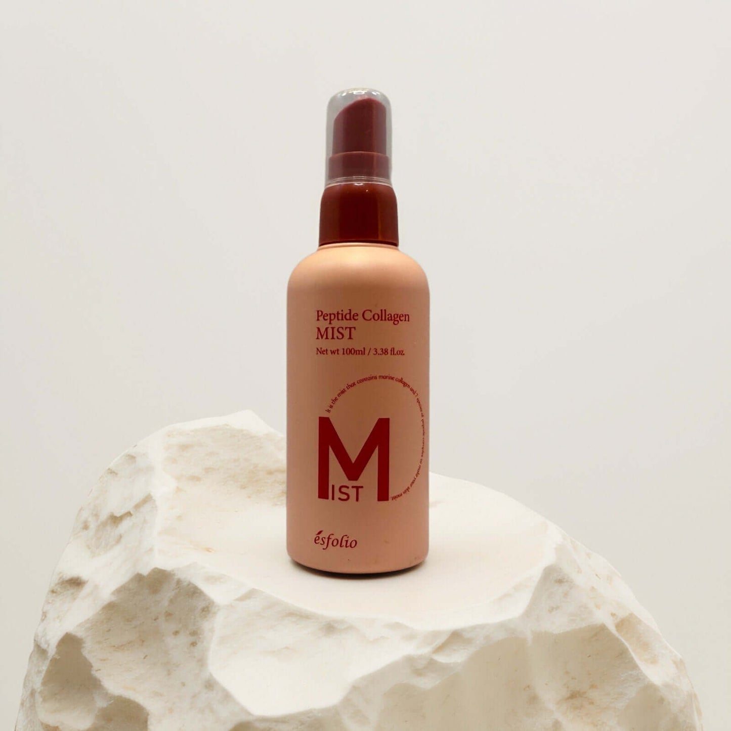 Esfolio Peptide Collagen Facial Mist on a textured surface.