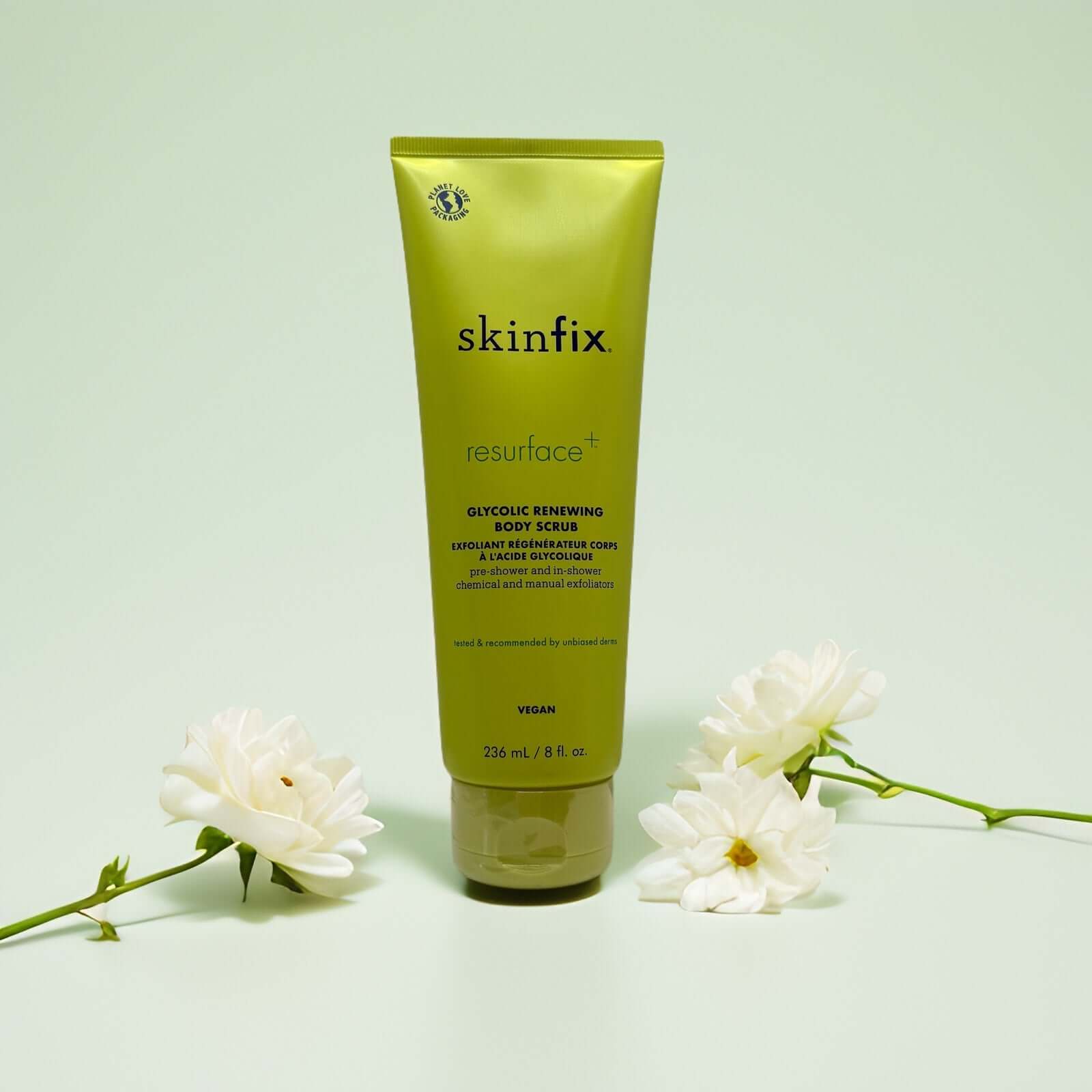 Glycolic Renewing Body Scrub by Skinfix in green tube with flowers