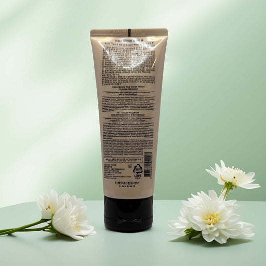 The Face Shop Rice Water Bright Foaming Cleanser back view with floral accents.