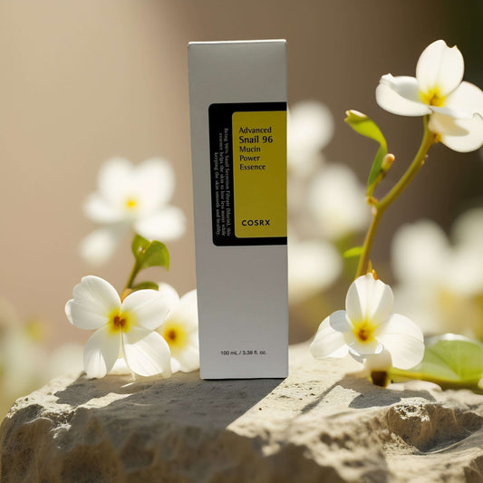 COSRX Advanced Snail 96 Mucin Power Essence with flowers, 3.4 fl oz, hydrating and repairing skincare.
