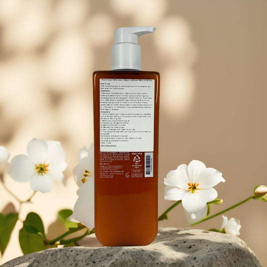 Nourishes & Repairs | Perfect Serum Original Conditioner by mise en scène – 22.99 fl oz displayed on a stone with flowers.