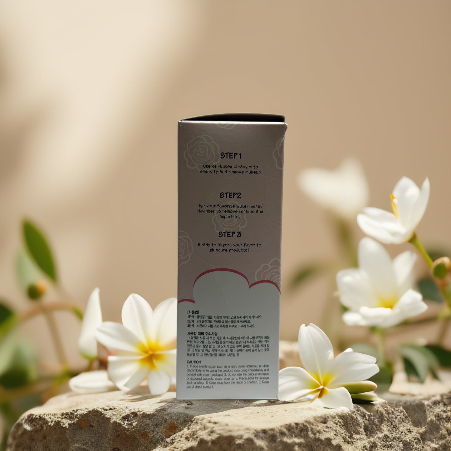 Step-by-step instructions for Esfolio Rose Cleansing Oil on packaging, surrounded by white flowers.