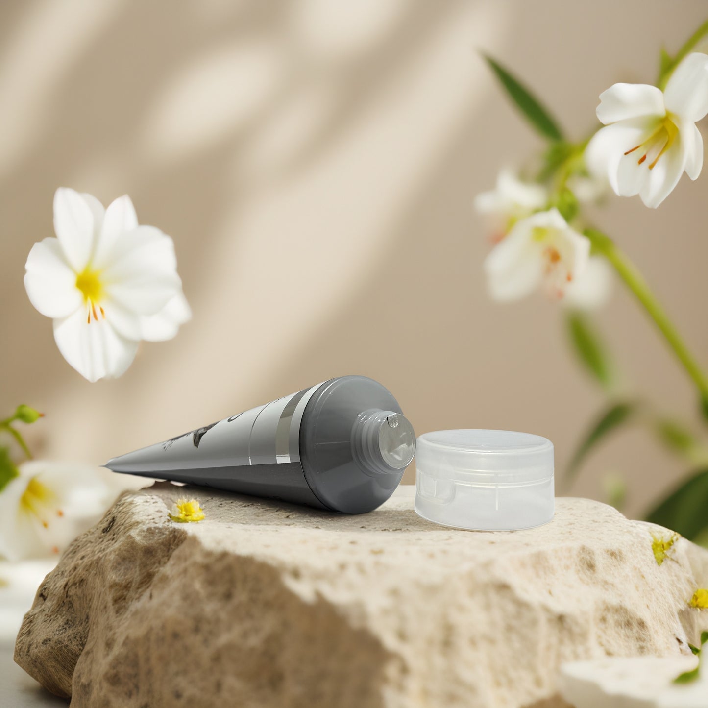 Pore Detox Charcoal Exfoliating Facial Scrub on a rock with flowers in the background, promoting clearer skin.