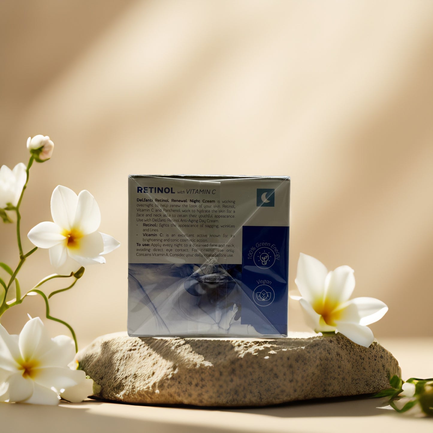 Delfanti Overnight Renewal & Brightening Retinol Night Cream packaging on a stone with flowers.