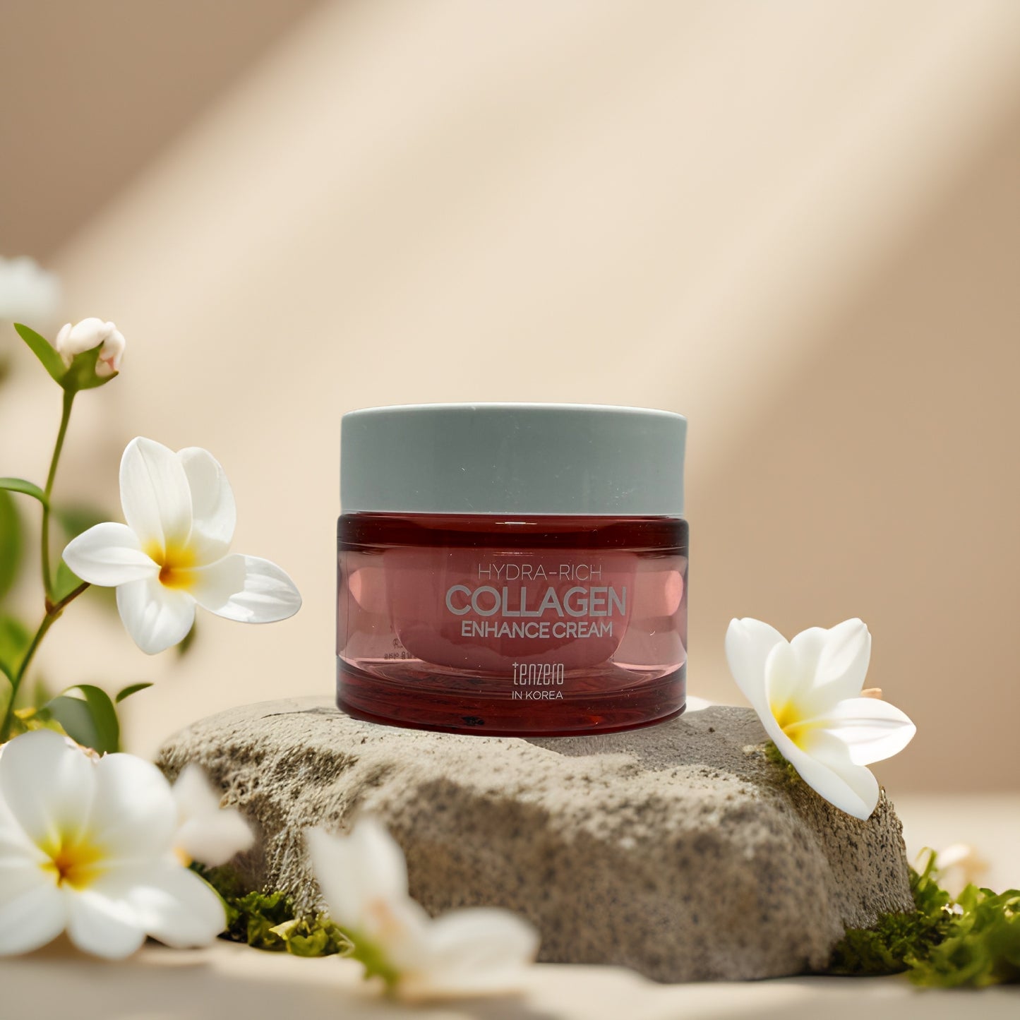 Firm & Smooth Collagen Enhance Cream by Tenzero in a jar surrounded by blooming flowers on a stone.