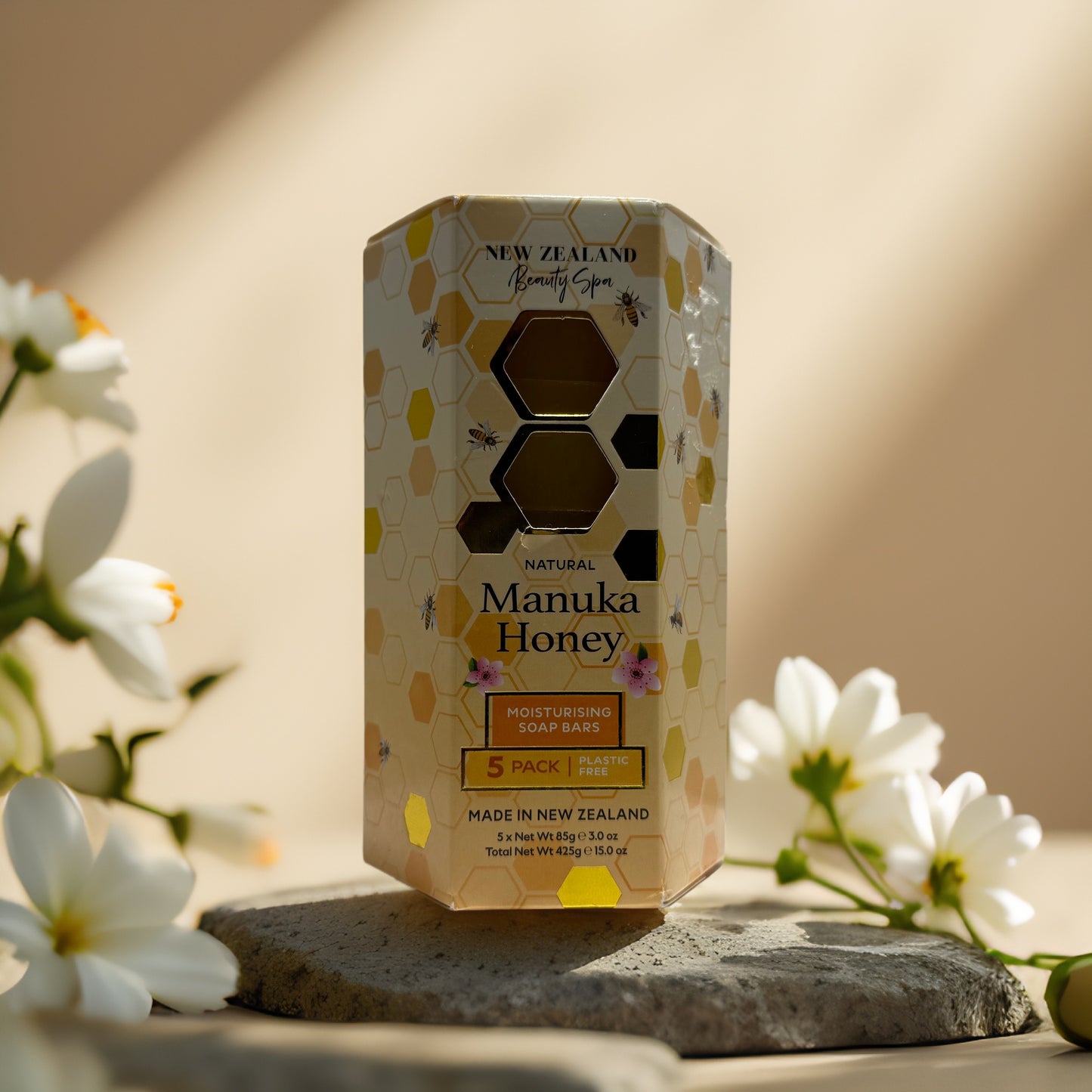 Nourish & Cleanse Manuka Honey Soap Bars pack by New Zealand Beauty Spa on display with flowers.