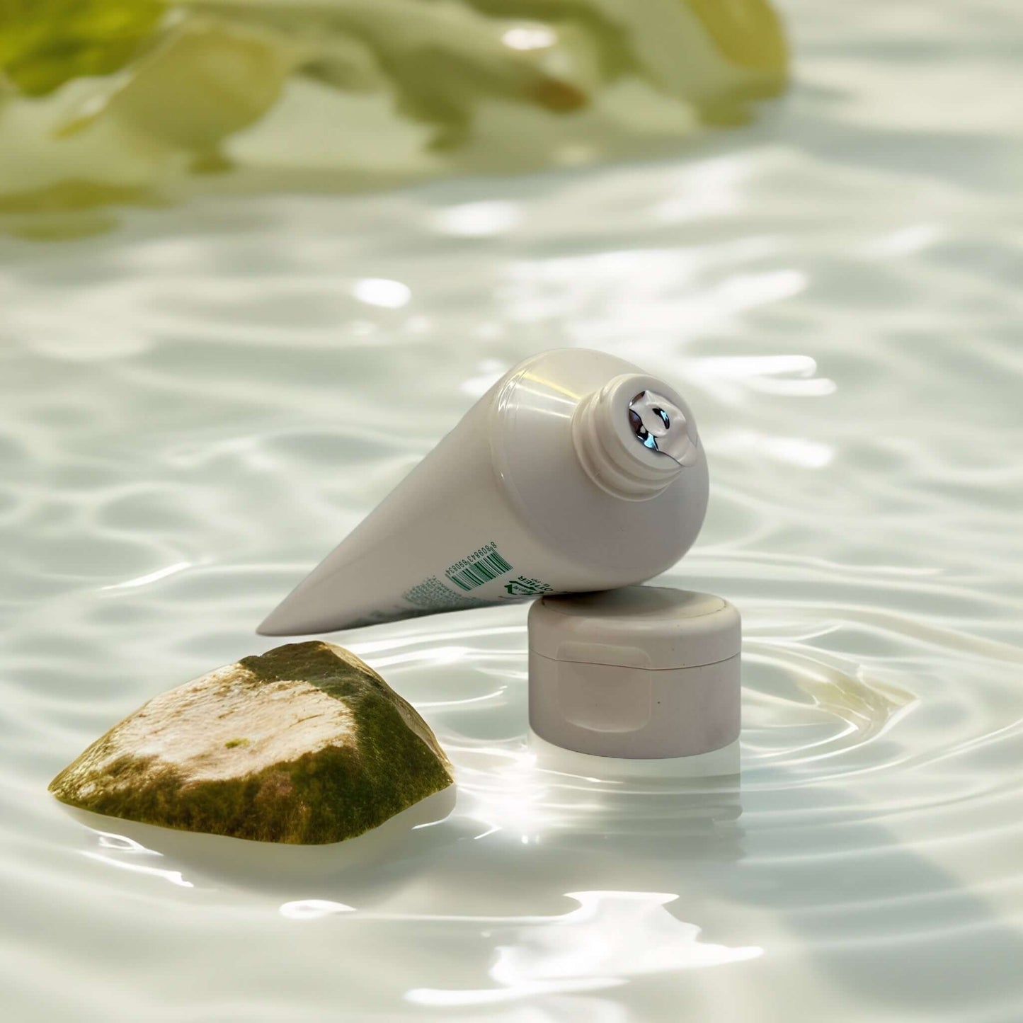 Innisfree Green Tea Amino Hydrating Cleansing Foam tube in water.