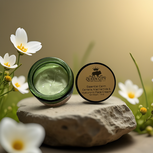 Essential Calm Face Cream by Queen City Skincare on a stone, featuring Centella Asiatica and hydration benefits.