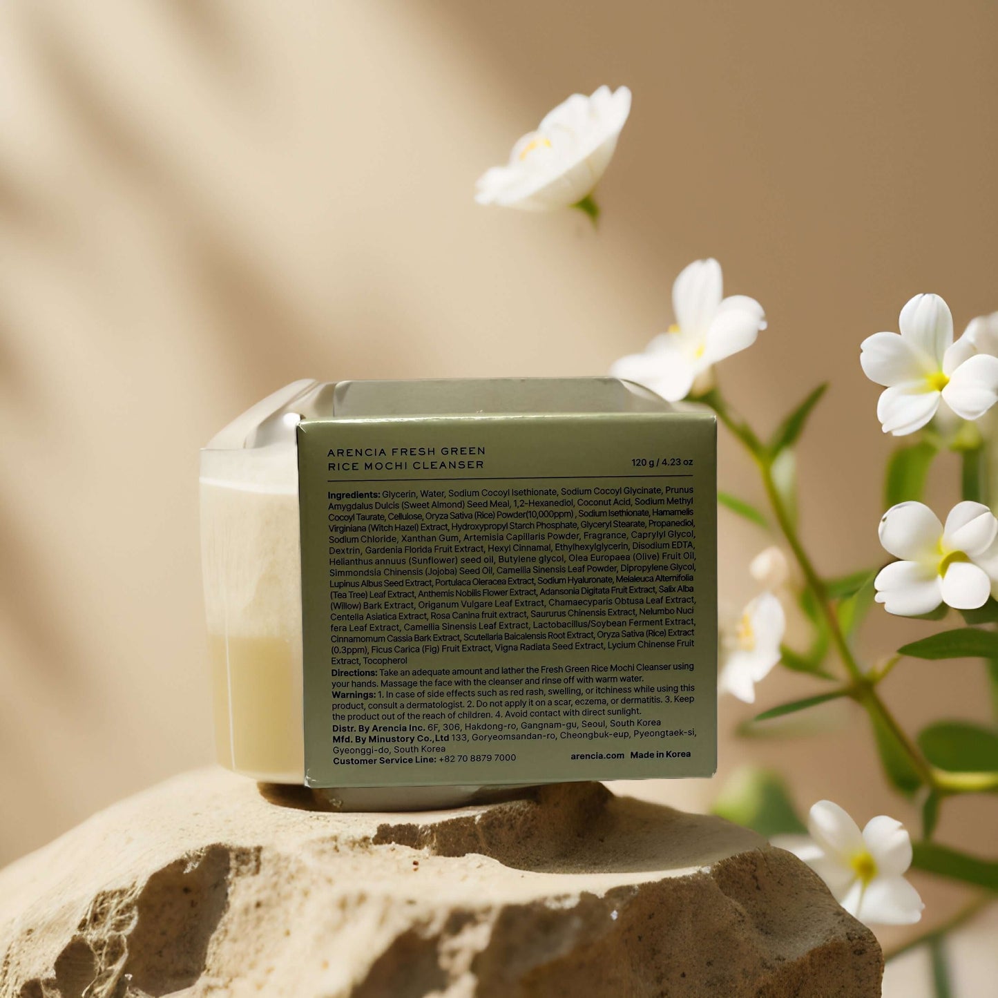 Arencia Rice Mochi Cleanser packaging with ingredients list, featuring a smooth, creamy texture in a natural setting.