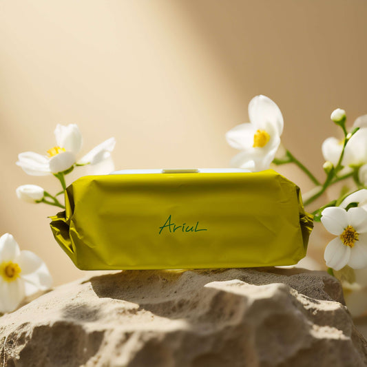 Ariul cleansing tissue pack against a soft floral background, perfect for quick facial refreshment.