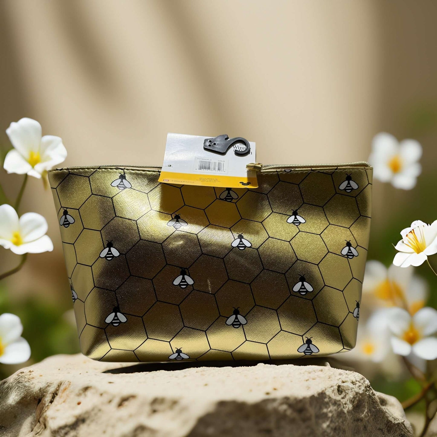 Winnie the Pooh gold travel pouch with honeycomb print and bees, perfect for makeup and travel essentials.