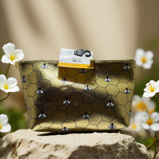 Winnie the Pooh gold travel pouch with honeycomb print and bees, perfect for makeup and travel essentials.