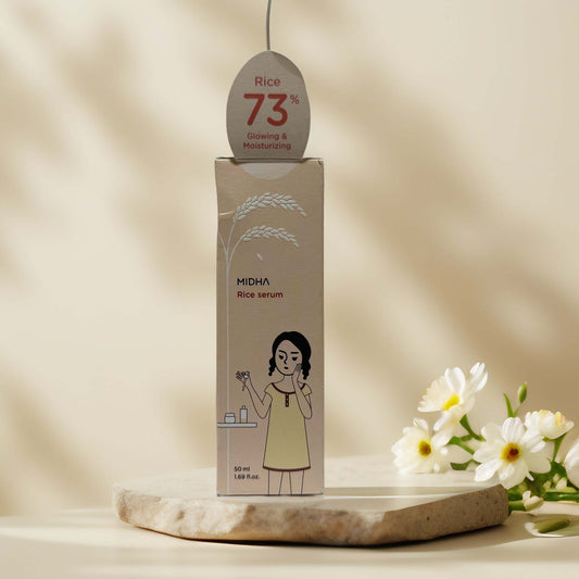MIDHA Rice Serum elegantly displayed with floral accents.