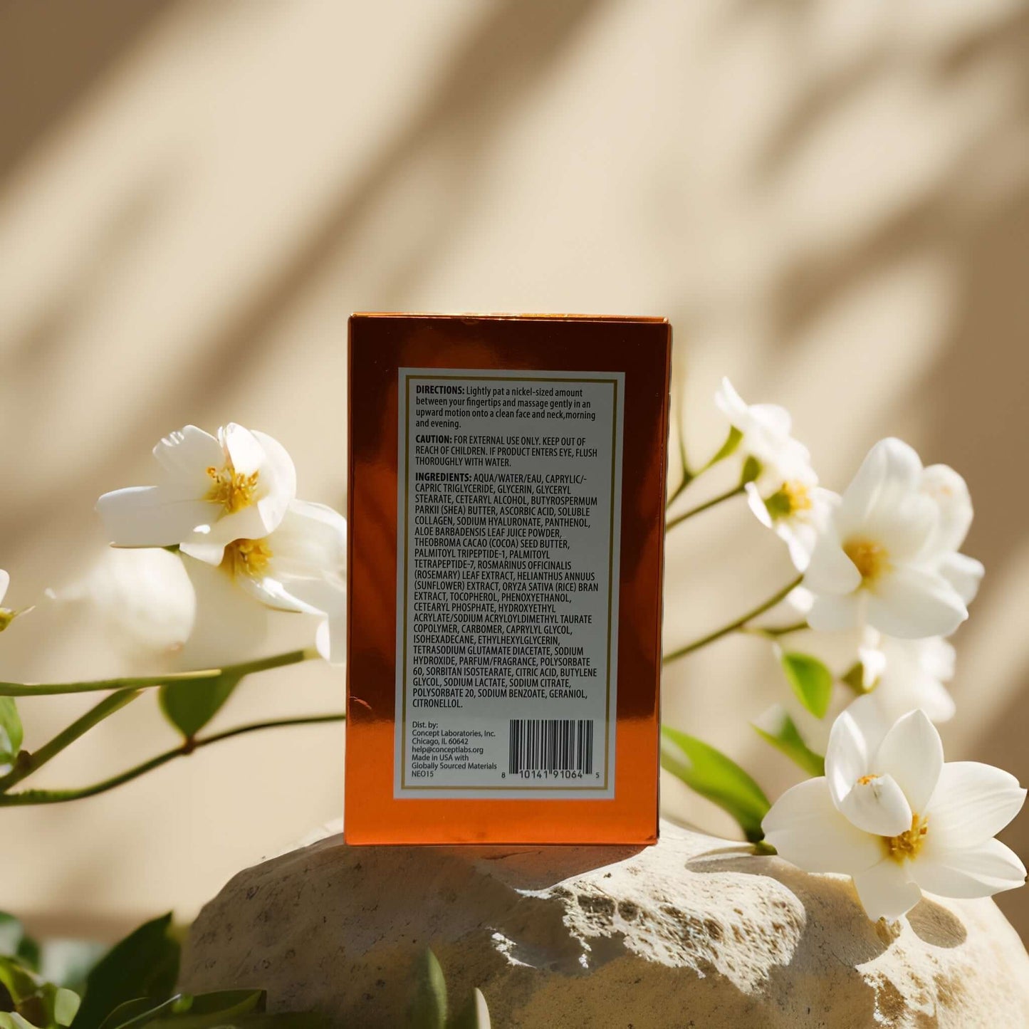 Back view of Neogold Vitamin C Face Cream box with ingredient list, surrounded by white flowers.