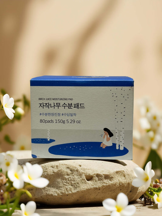 Calm & Quench Birch Juice Moisturizing Pad box with floral background, 80 pads, hydrating toner for skin care.
