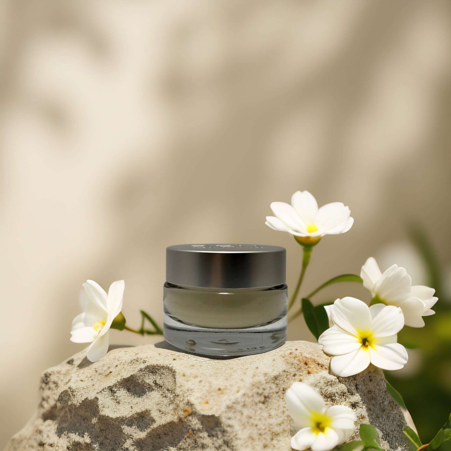 Calming & Barrier Repair Day Cream by REN on a rock with flowers, soothing sensitive skin and protecting the skin barrier.
