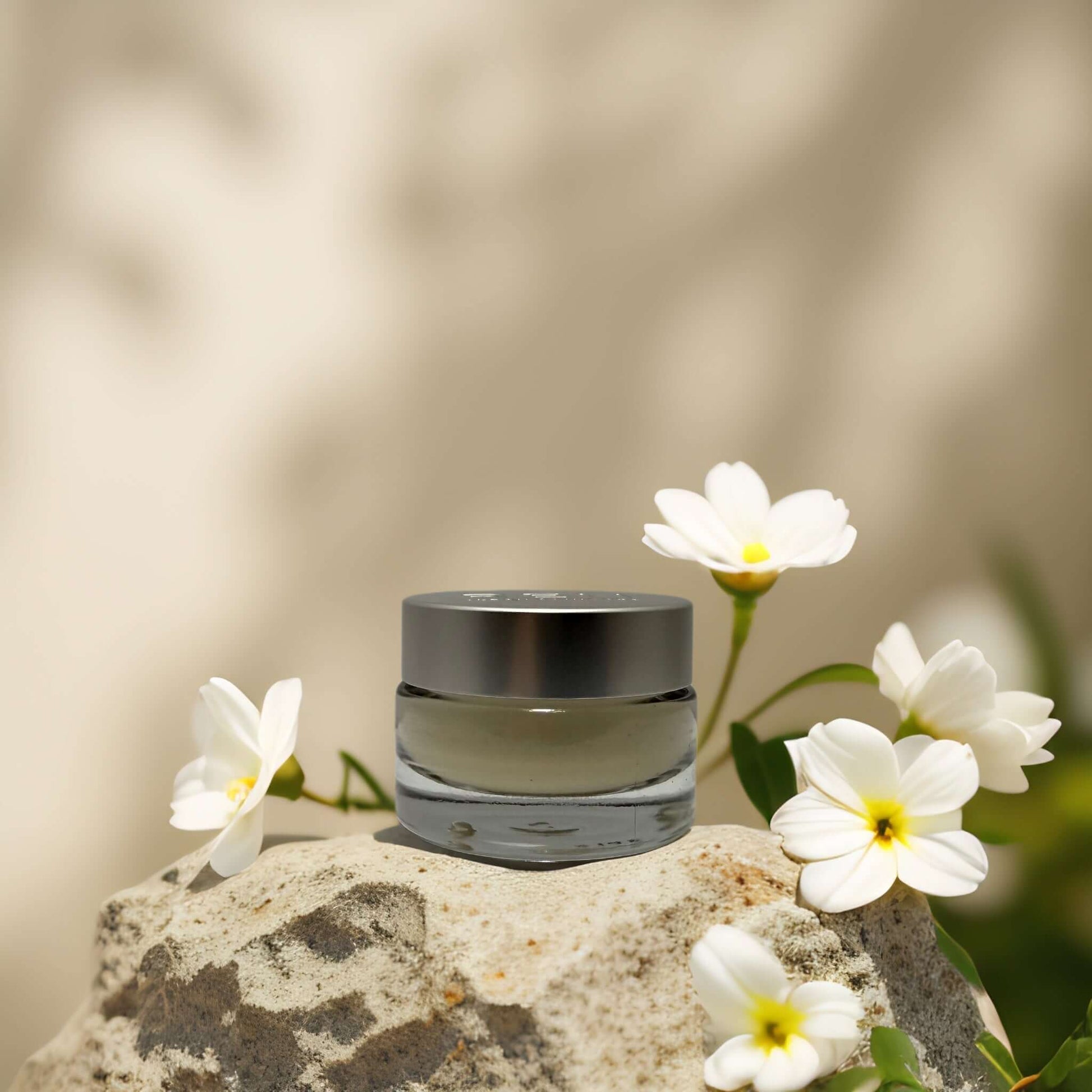 Calming & Barrier Repair Day Cream by REN on a rock with flowers, soothing sensitive skin and protecting the skin barrier.