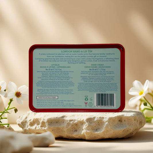 Back of Cath Kidston London Hand & Lip Tin with product details and ingredients on a natural stone surface.