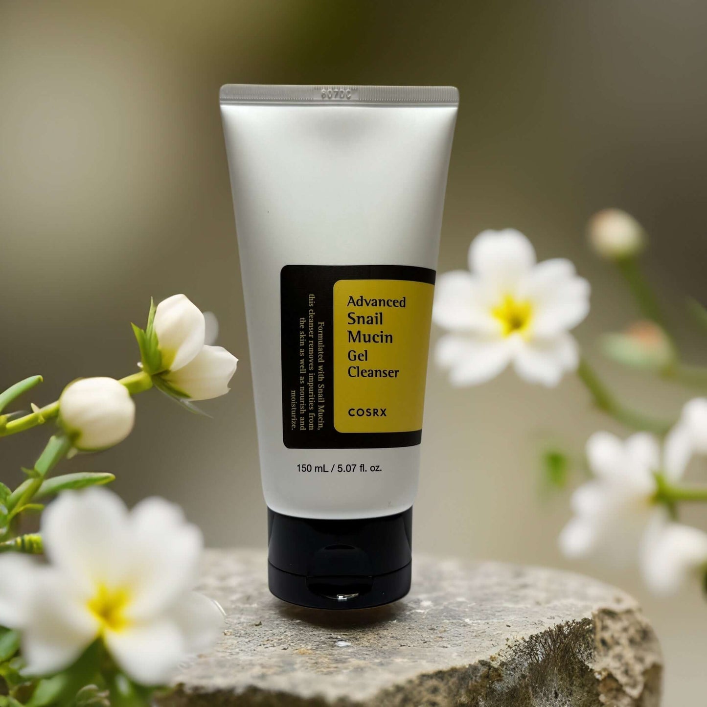 COSRX Advanced Snail Mucin Gel Cleanser in a tube with flowers, 5.07 oz, hydrating formula for gentle cleansing.