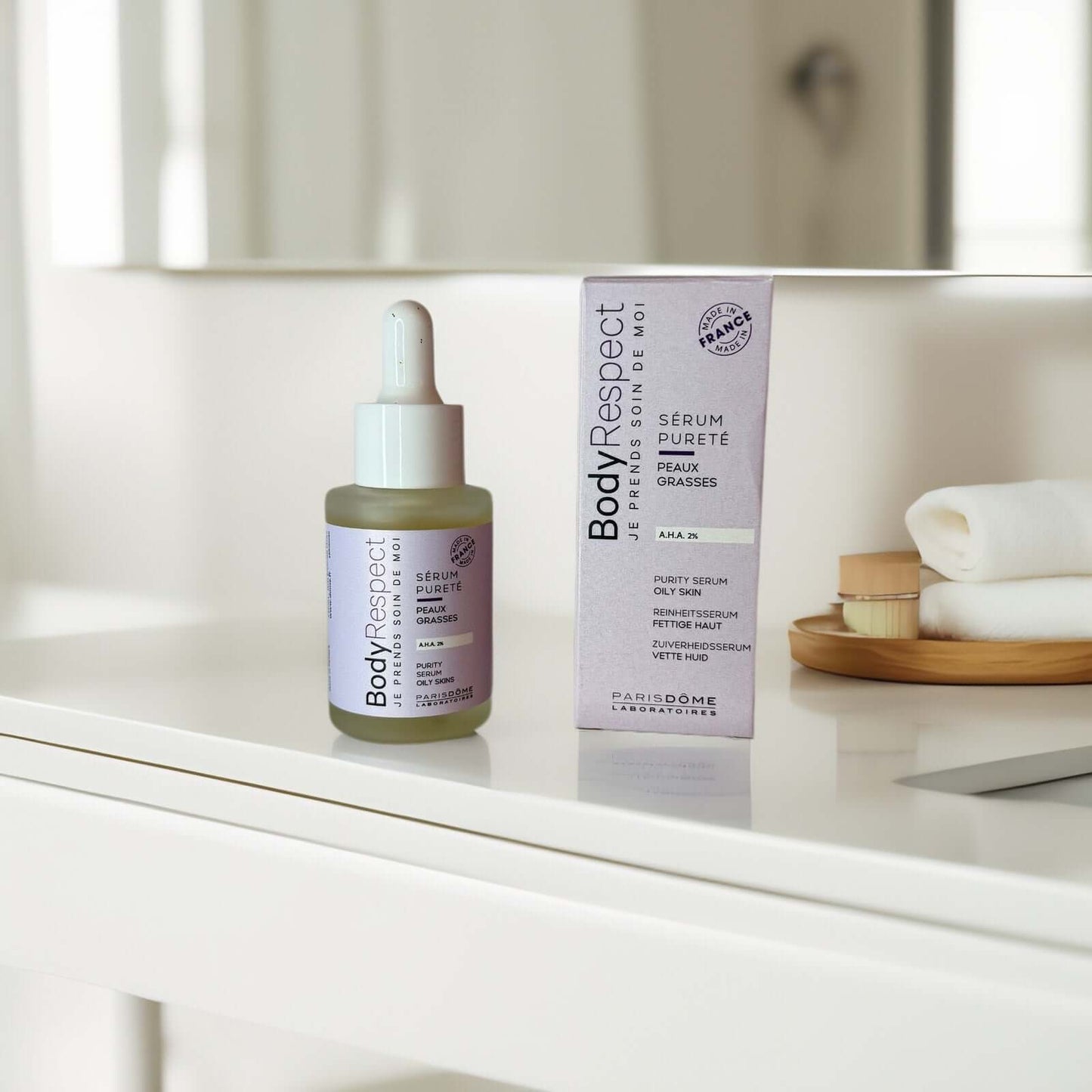 AHA 2% Purity Serum by Body Respect on a vanity table.