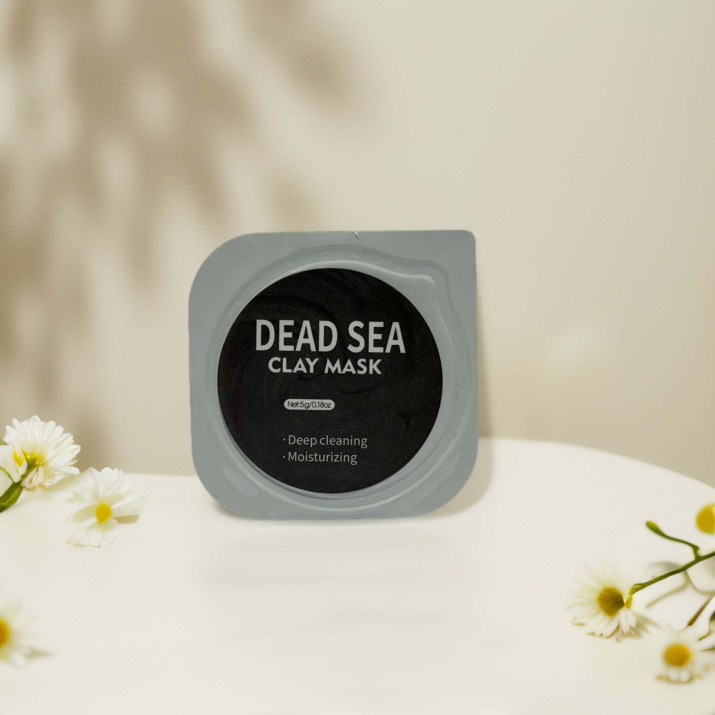 Dead Sea clay mask pod for deep cleansing and moisturizing, perfect for oily or congested skin treatment.