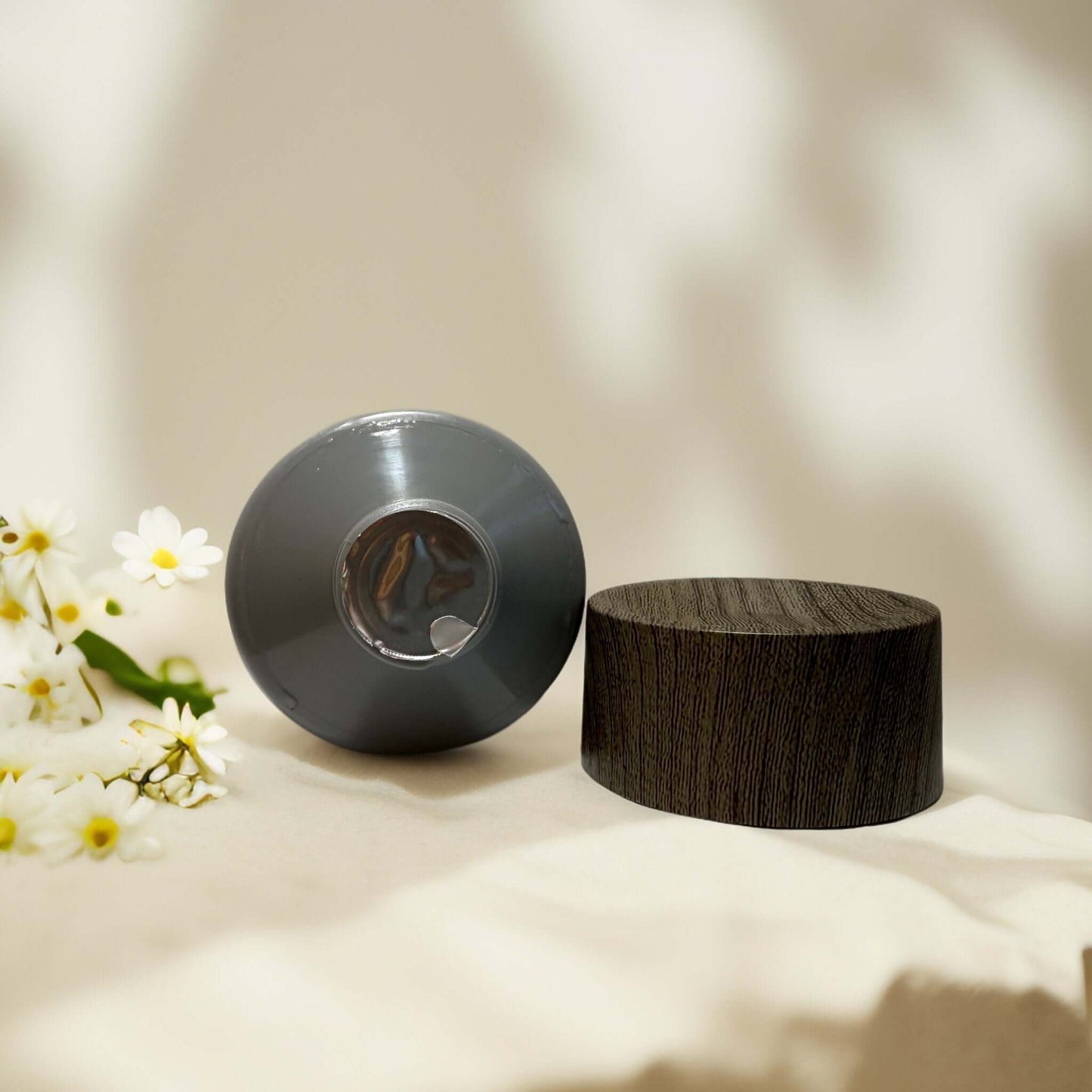 Blackstone Face Scrub with wood-like cap and floral background