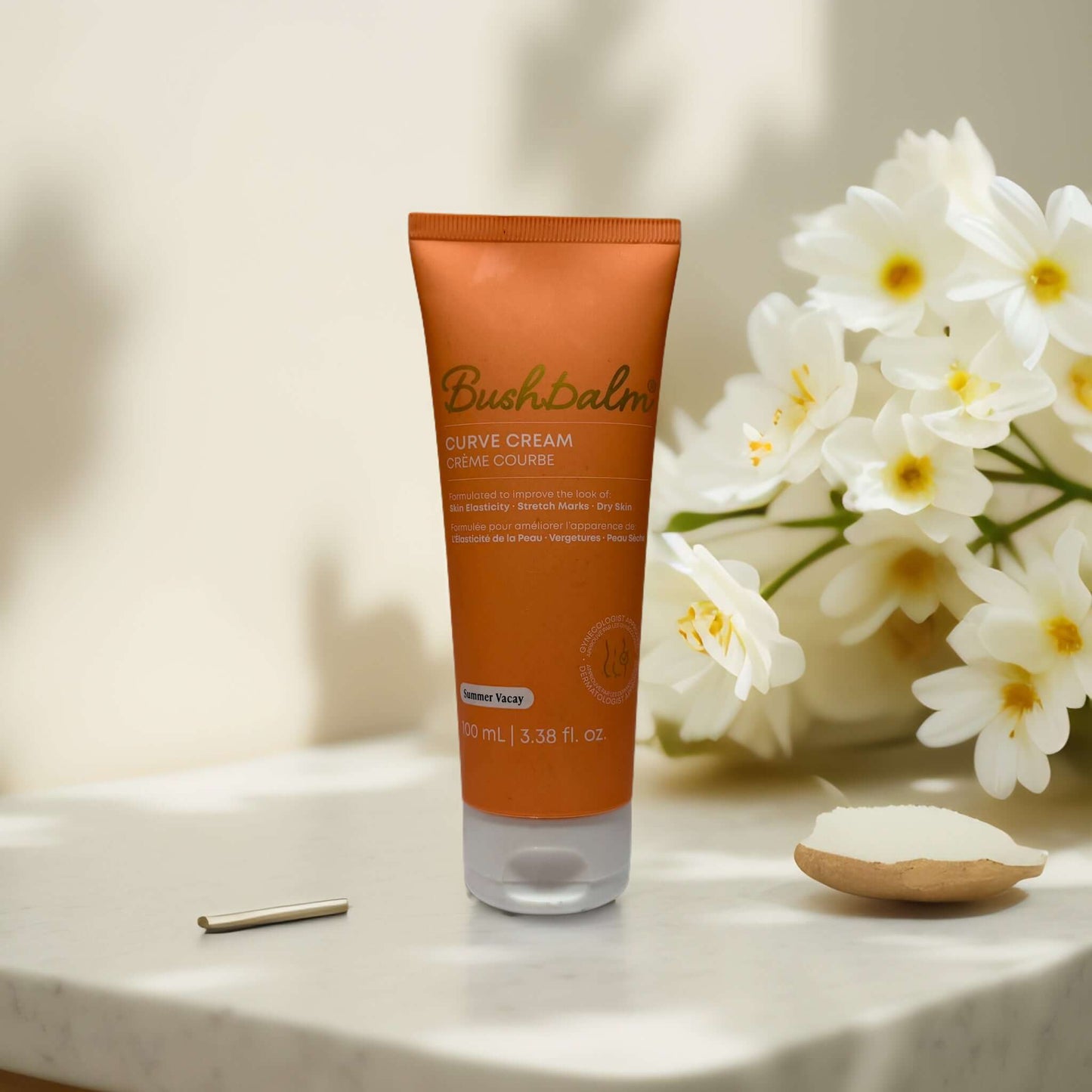 Firm & Smooth Bush Balm Curve Cream on a table with flowers.
