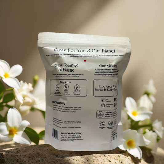 Fomin Aromatherapy Boost Shower Steamers pouch with natural ingredients and eco-friendly message surrounded by flowers.