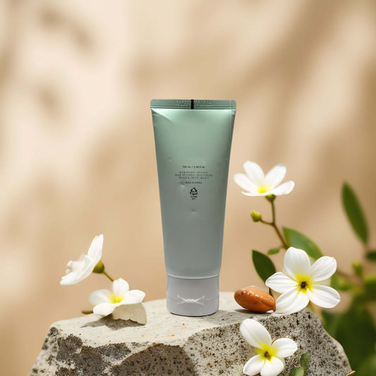 Gentle Daily Cleanse by Beauty of Joseon in a pastel green tube surrounded by white flowers on a stone.