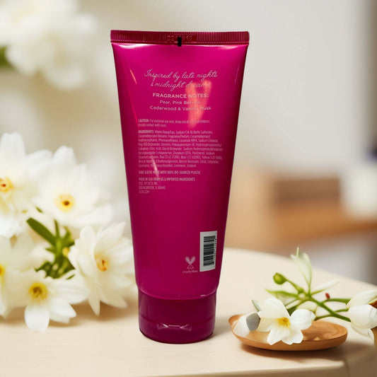 Back of Whim Glittering Nights Body Wash tube with floral decor.