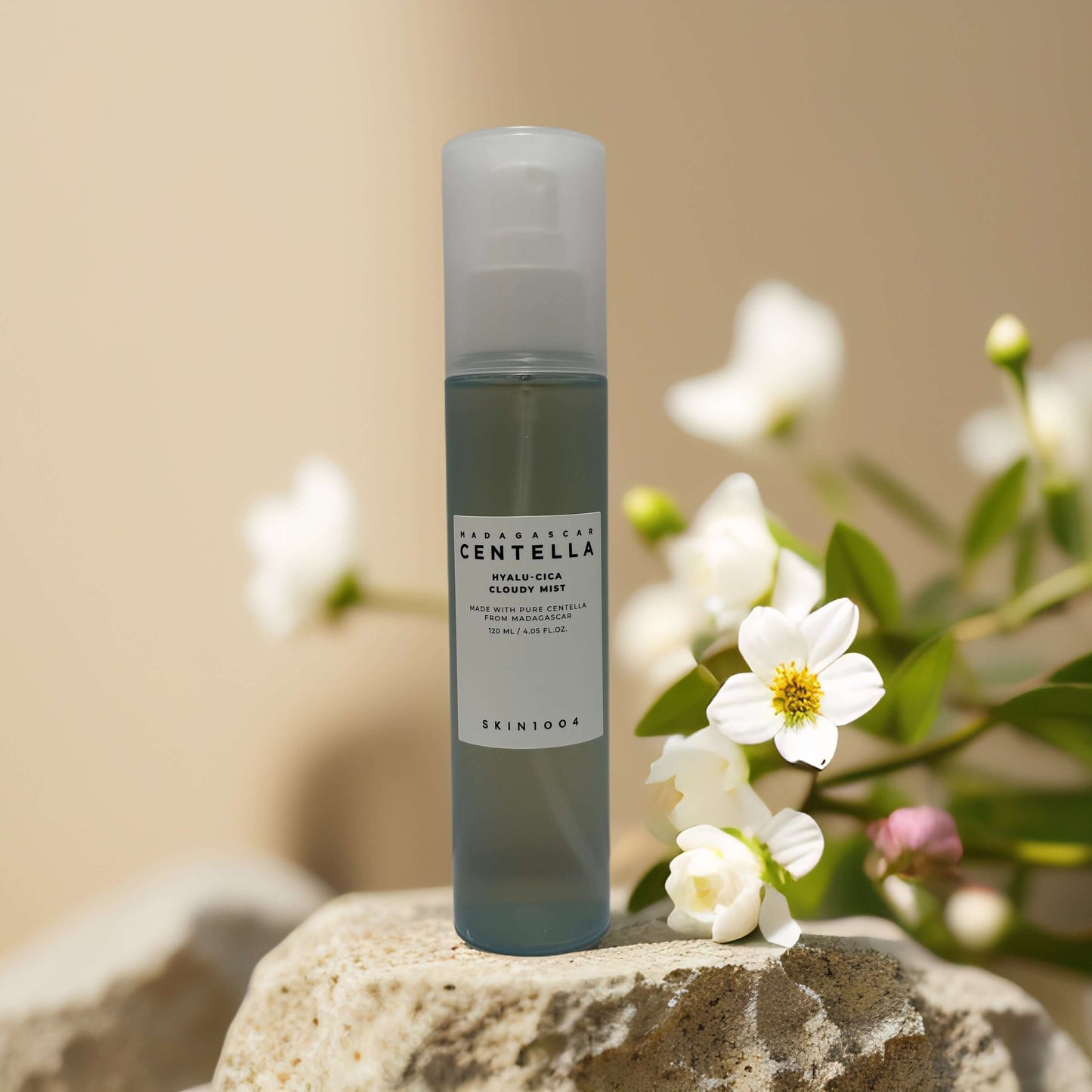 Hydrating Barrier Mist by SKIN1004 in a bottle with flowers, delivering calming hydration for sensitive skin.