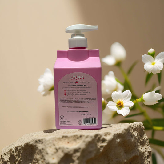 Back view of Crème Strawberry Oat Milk Body Cleanser bottle with floral background.