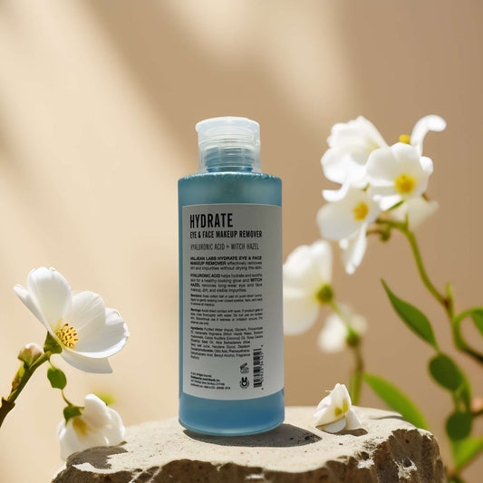 Hydrating eye and face makeup remover by Valjean Labs, featuring Hyaluronic Acid and Witch Hazel in a serene setting.