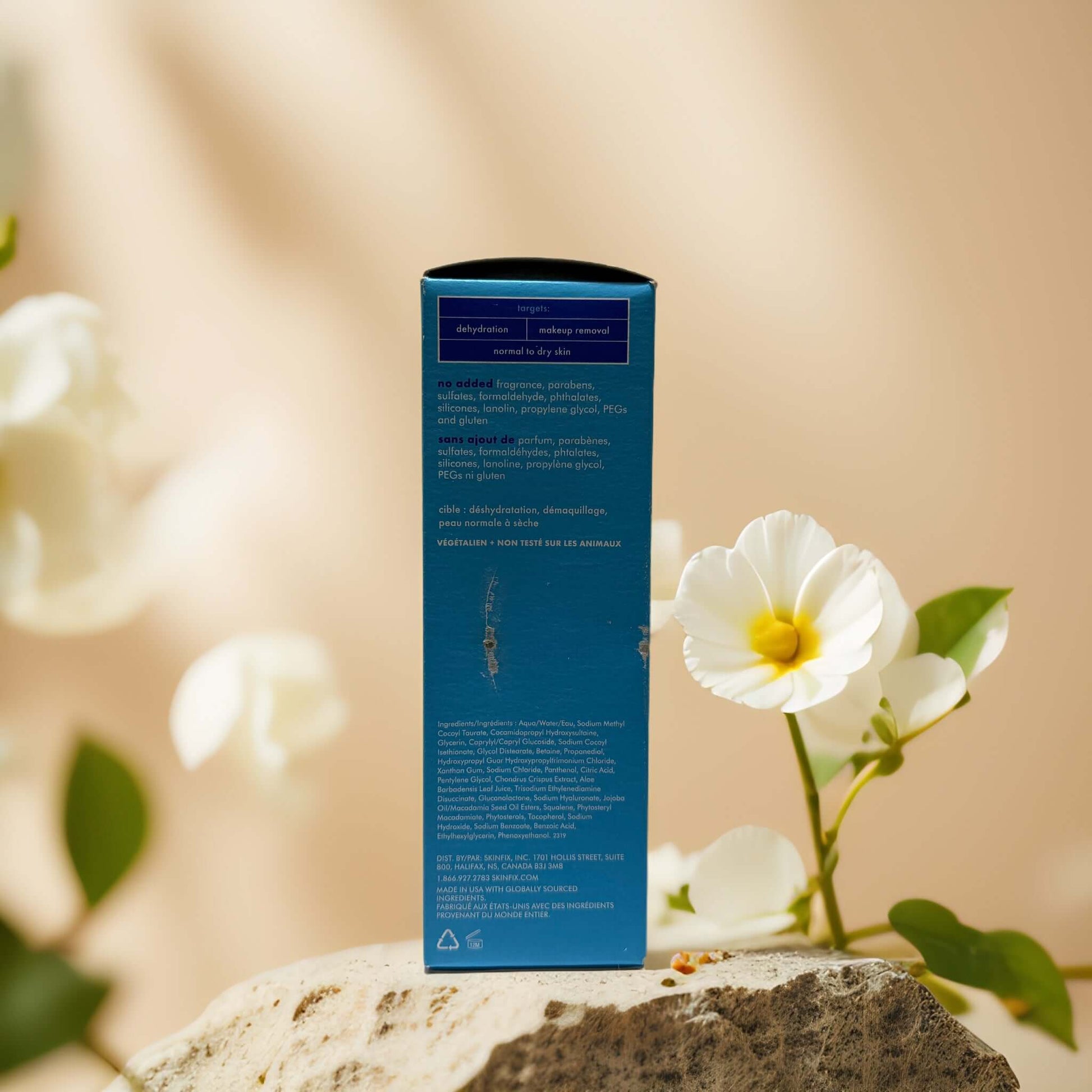 Skinfix Hydrating Cleanse foaming oil facial cleanser packaging against a floral backdrop.