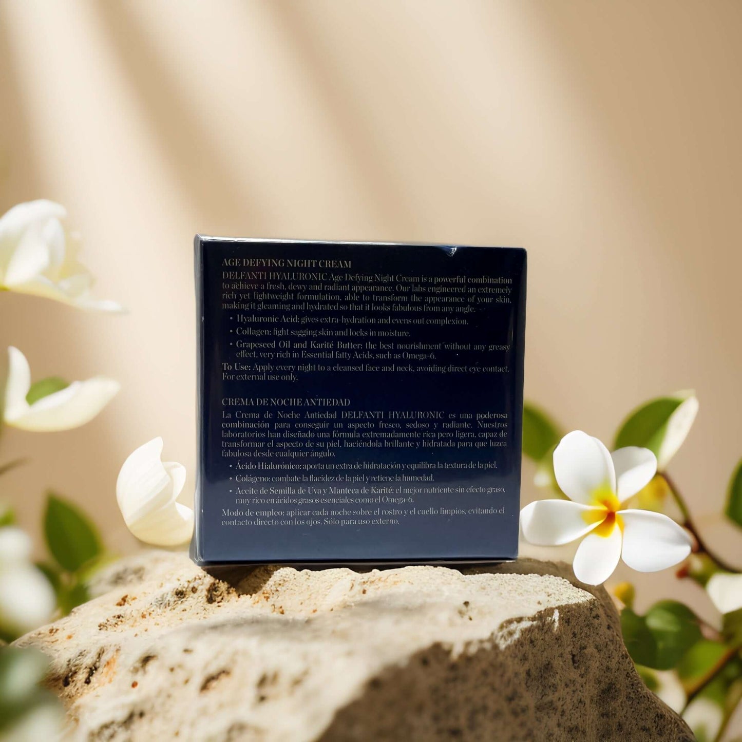 Hydrating Overnight Repair night cream box, featuring product details and benefits, set on a stone with tropical flowers.