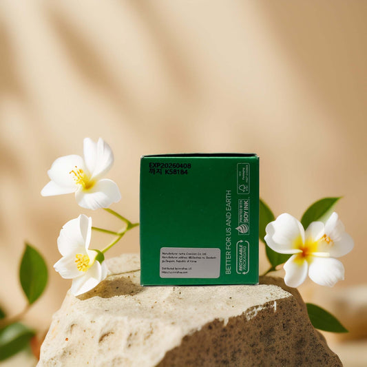 Innisfree Deep Pore Detox clay mask packaging with flowers on a stone surface.