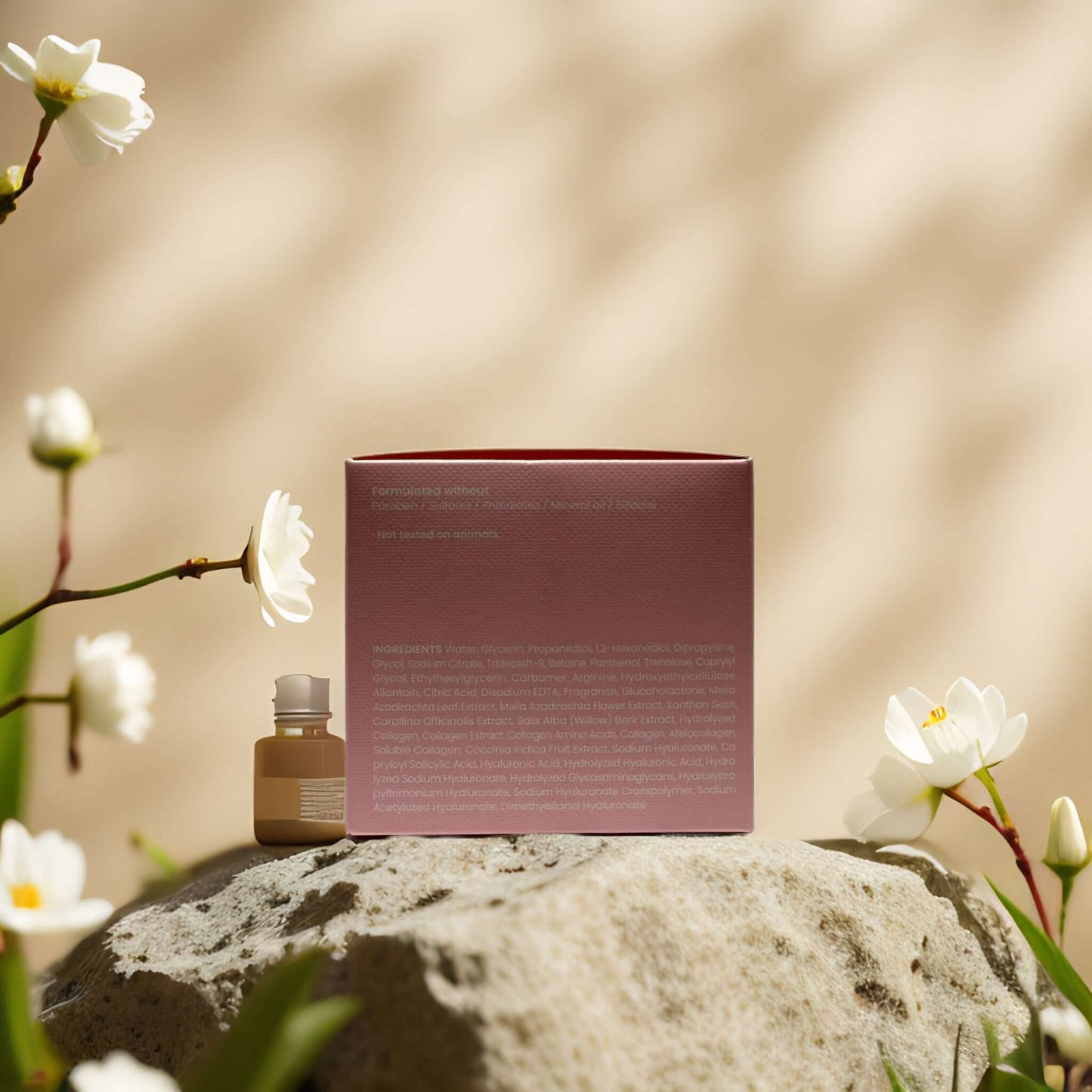 Collagen essence pads by Maske Lab on a stone surrounded by flowers, showcasing elegant packaging and product.