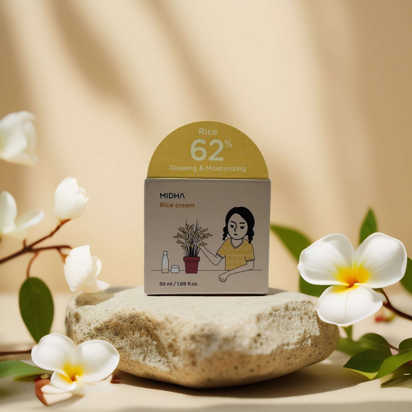MIDHA Rice Facial Cream box featuring 62% rice water, with illustrations on a stone background.
