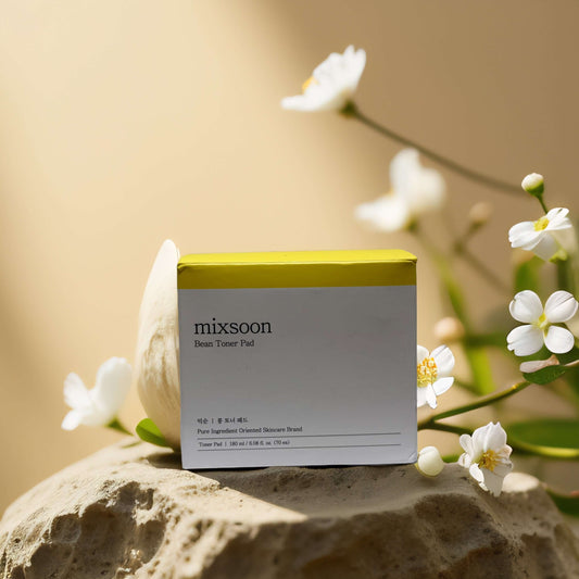mixsoon Bean Toner Pads in a minimalist box with floral background, promoting gentle exfoliation and hydration.