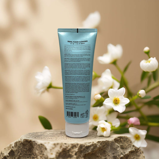Moisture-Rich Snail Foam Cleanser by Bonnyhill in a tube, 8.5 fl oz, surrounded by white flowers.