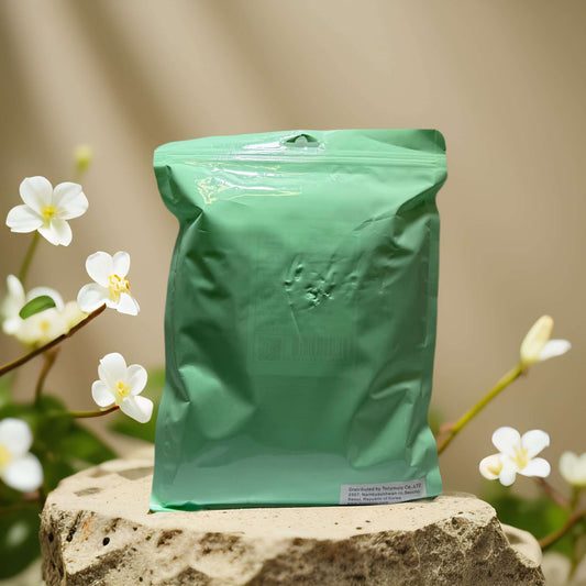 Nourishing sheet mask set packaging by TonyMoly on a stone surface with white flowers in the background.