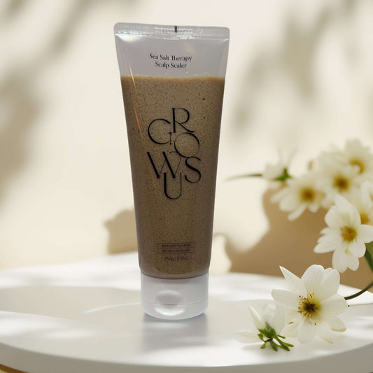 Growus Sea Salt Therapy Scalp Scaler in a tube on display.