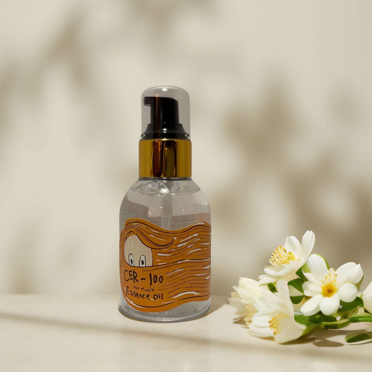 Elizavecca CER-100 Hair Muscle Essence Oil bottle with flowers