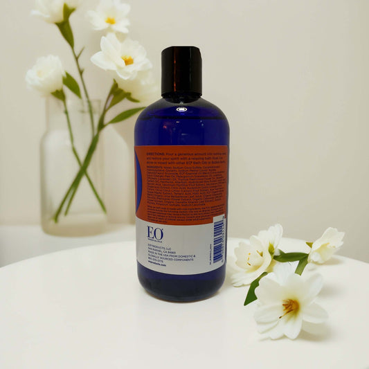 EO Bubble Bath bottle with floral accents on a table.