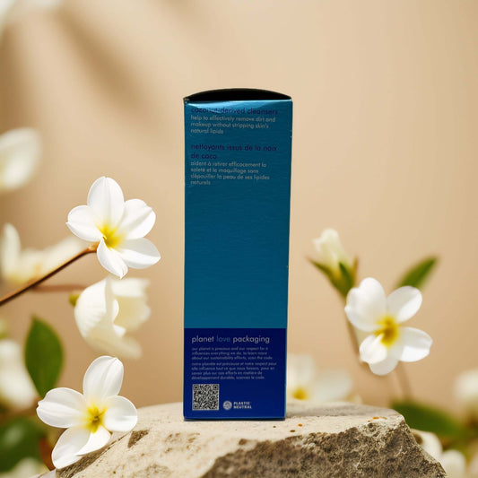 Back view of Skinfix Hydrating Cleanse packaging on a stone with flowers, showcasing eco-friendly design and QR code.