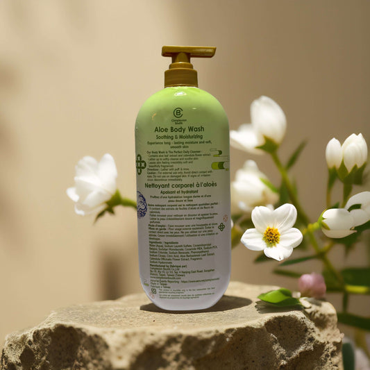 Aloe Body Wash by Complexion Boutik, soothing formula in a 33.8 fl oz bottle, surrounded by flowers.