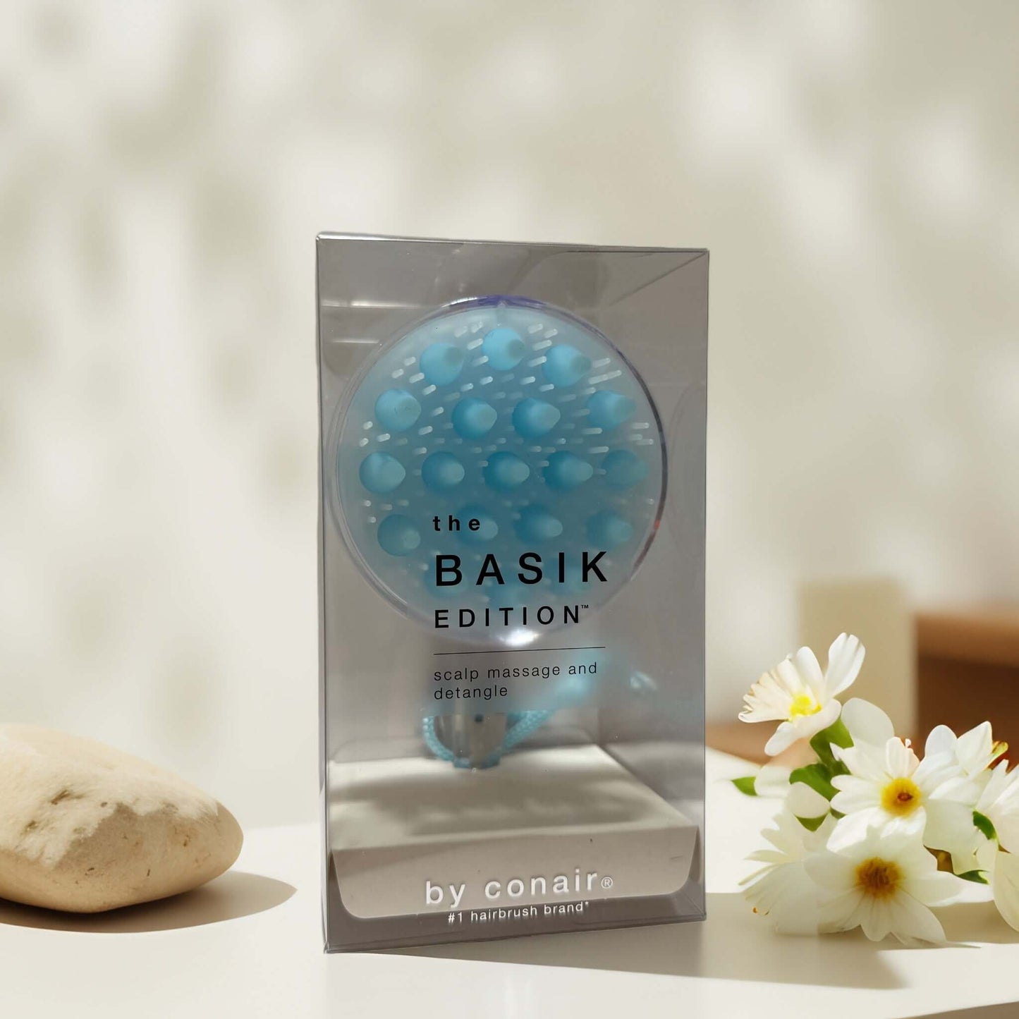Soothing scalp massage brush in packaging by Conair.