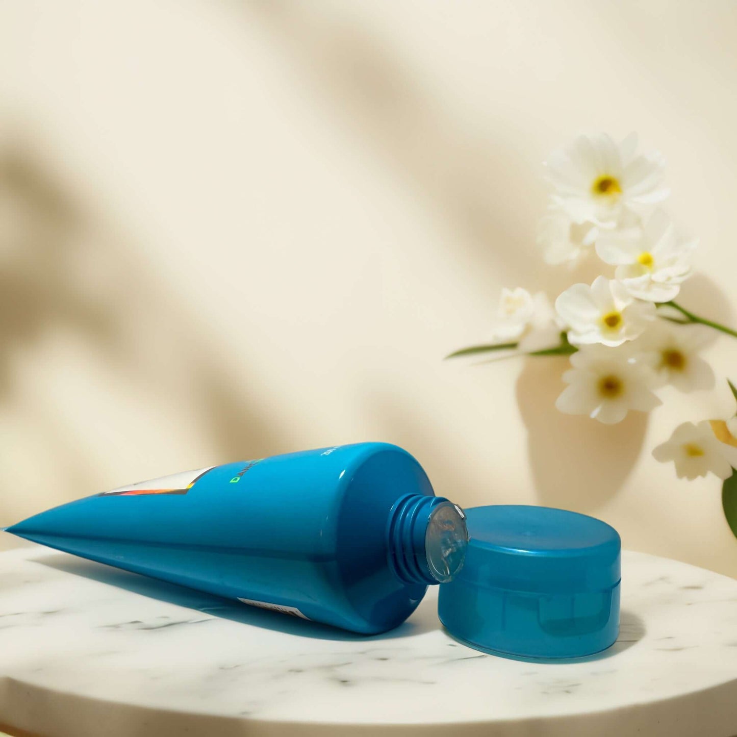 Sparkling Cloud scented body wash in blue tube on marble