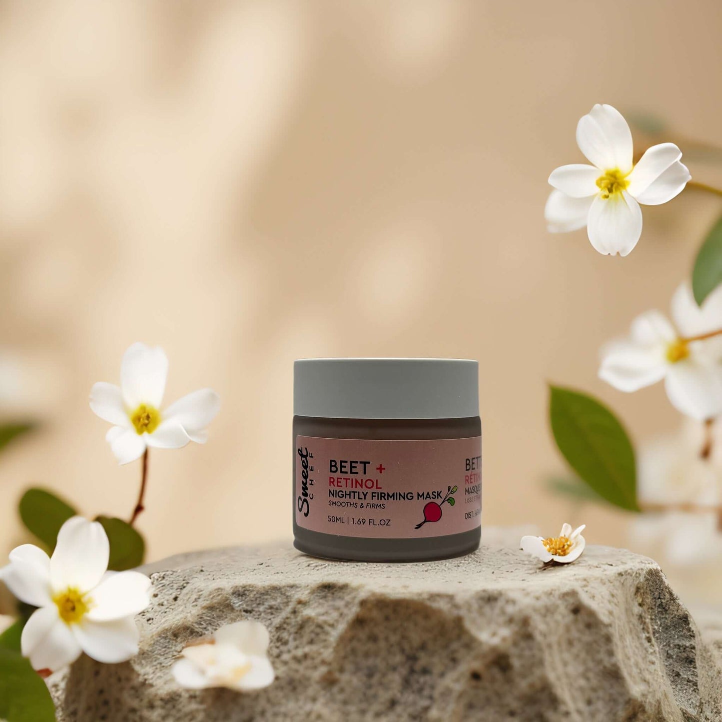 Firm & Smooth Beet + Retinol Night Mask by Sweet Chef in a scenic setting with flowers, promoting hydration and firmness.