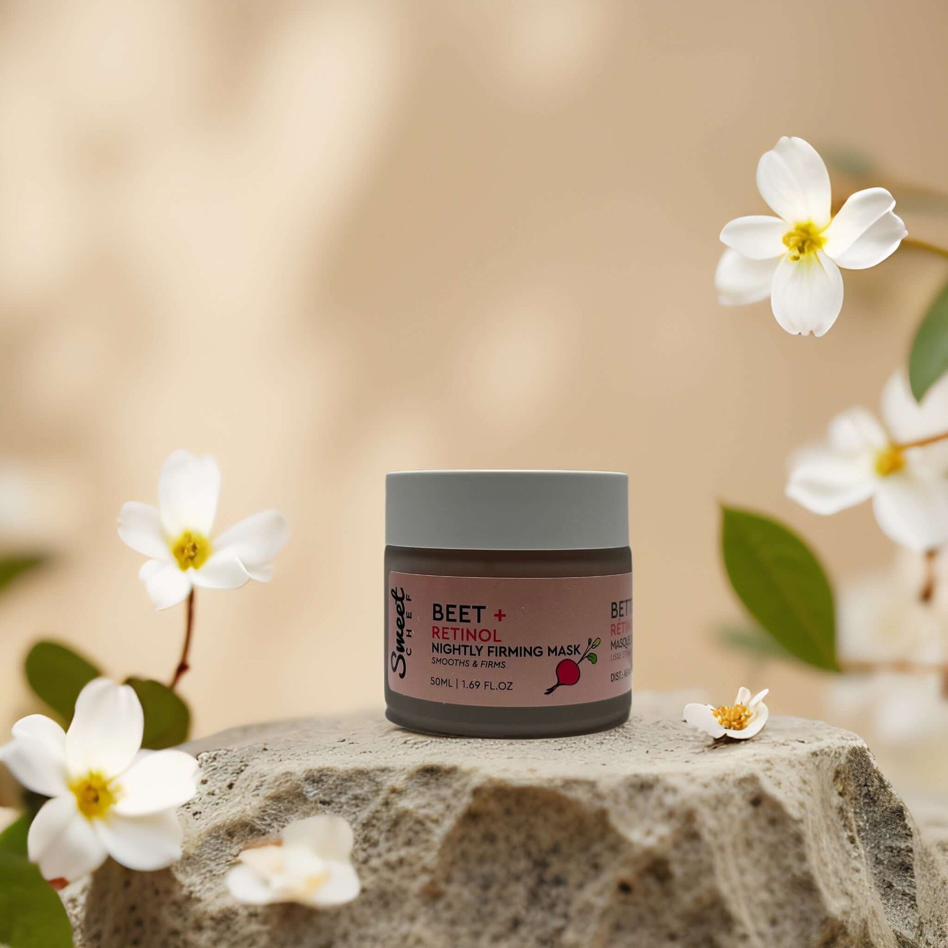 Firm & Smooth Beet + Retinol Night Mask by Sweet Chef in a scenic setting with flowers, promoting hydration and firmness.
